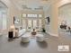 Bright living room featuring modern furnishings, a decorative ceiling, and french doors leading to the backyard at 4520 Old Carriage Trl, Oviedo, FL 32765