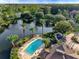 Community pool and lakefront property with lush landscaping at 4849 Cypress Woods Dr # 1310, Orlando, FL 32811