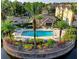 Resort-style pool with clubhouse, lush landscaping, and serene lake views at 4849 Cypress Woods Dr # 1310, Orlando, FL 32811