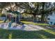 Community playground with playset and picnic table under tree at 5021 Saint Michael Ave, Belle Isle, FL 32812