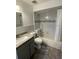 Updated bathroom with granite vanity, bathtub, and marble-look tile at 513 Harvard Pl, Apopka, FL 32703
