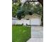 House exterior showcasing a white garage door and a neatly kept lawn at 513 Harvard Pl, Apopka, FL 32703