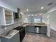 Modern kitchen with stainless steel appliances and granite countertops at 513 Harvard Pl, Apopka, FL 32703