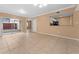 Spacious living area with tile floors and kitchen view at 533 Villa Del Sol Cir # 103, Orlando, FL 32824