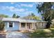 Light blue house with a covered porch and manicured lawn at 540 Fern Ave, Tavares, FL 32778