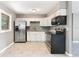 Renovated kitchen featuring stainless steel appliances and white cabinets at 540 Fern Ave, Tavares, FL 32778