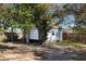 White shed with roll-up door in backyard at 540 Fern Ave, Tavares, FL 32778