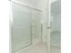 Clean bathroom with a walk-in shower, neutral tile, and a sliding glass door at 5701 Le Marin Way, Kissimmee, FL 34758