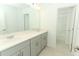 Modern bathroom with double vanity, light gray cabinets, and a tub at 5701 Le Marin Way, Kissimmee, FL 34758