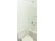 Clean bathroom with a shower/tub combo, neutral tones and shelving at 5701 Le Marin Way, Kissimmee, FL 34758