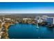 Scenic aerial view of a lakefront community with lush trees and city skyline in the distance at 606 E Amelia St, Orlando, FL 32803