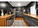 Modern bar area with dark cabinetry, wood countertops, and a built-in shelving unit at 606 E Amelia St, Orlando, FL 32803