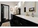 Bathroom with marble countertops, double sinks, and black hexagonal tile floor at 606 E Amelia St, Orlando, FL 32803