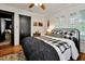 Spacious bedroom with wood floors, window shutters, and a comfy bed at 606 E Amelia St, Orlando, FL 32803