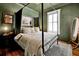 Charming bedroom with four poster bed and green walls at 606 E Amelia St, Orlando, FL 32803