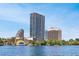 Picturesque lakefront view of a city skyline with modern buildings and a vibrant park with colorful public art at 606 E Amelia St, Orlando, FL 32803