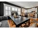 Farmhouse style dining area with a large black table and white kitchen in background at 606 E Amelia St, Orlando, FL 32803