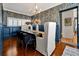Formal dining room with dark blue wainscoting and a statement wallpaper at 606 E Amelia St, Orlando, FL 32803