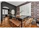 Bright dining room with a dark wood table, floral wallpaper, and wood floors at 606 E Amelia St, Orlando, FL 32803