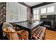 Elegant dining room with dark wood table, patterned wallpaper, and built-in bench seating at 606 E Amelia St, Orlando, FL 32803