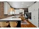 U-shaped kitchen with white cabinets, brick accent wall, and a large island at 606 E Amelia St, Orlando, FL 32803
