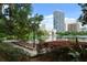 Breathtaking lake view with modern buildings, a rainbow sculpture, and lush trees, perfect for relaxation at 606 E Amelia St, Orlando, FL 32803