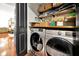 Laundry room with washer, dryer, and wood floors at 606 E Amelia St, Orlando, FL 32803
