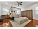 Spacious main bedroom with a four-poster bed, hardwood floors, and built in wardrobe at 606 E Amelia St, Orlando, FL 32803