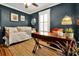 Home office with daybed, wooden desk, and wood floors at 606 E Amelia St, Orlando, FL 32803