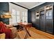 Home office with wood floors, built-in shelving, and window shutters at 606 E Amelia St, Orlando, FL 32803