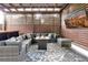 Relaxing outdoor patio with fire pit, sectional sofa, and TV at 606 E Amelia St, Orlando, FL 32803