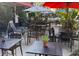 Charming outdoor patio area features ample seating with tables, umbrellas, and lush greenery at 606 E Amelia St, Orlando, FL 32803