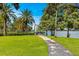 Scenic park view featuring lush greenery, palm trees, a walking path, and lakefront access, perfect for outdoor activities at 606 E Amelia St, Orlando, FL 32803