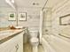 Clean bathroom with granite vanity and bathtub at 6165 Carrier Dr # 3707, Orlando, FL 32819