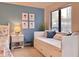 White daybed with storage and blue pillows at 6165 Carrier Dr # 3707, Orlando, FL 32819