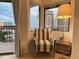 Living area features a striped armchair and large windows with city views at 6165 Carrier Dr # 3707, Orlando, FL 32819