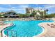 Resort-style pool with plenty of lounge chairs for relaxation at 6165 Carrier Dr # 3707, Orlando, FL 32819
