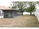 Backyard view of house and screened porch at 741 Caribou Dr, Kissimmee, FL 34759