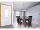 Dining room with black table and chairs, and a white door at 741 Caribou Dr, Kissimmee, FL 34759