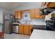 Kitchen offers wood cabinets, stainless steel appliances, and ample counter space at 741 Caribou Dr, Kissimmee, FL 34759