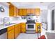 Kitchen with wood cabinets, stainless steel appliances, and tile floor at 741 Caribou Dr, Kissimmee, FL 34759