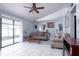 Living room features two sofas, coffee table, and sliding glass doors at 741 Caribou Dr, Kissimmee, FL 34759
