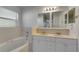 Bathroom with double vanity, bathtub, and window at 849 Jarnac Dr, Kissimmee, FL 34759