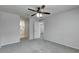 Bedroom with gray carpet, ceiling fan, and access to bathroom at 849 Jarnac Dr, Kissimmee, FL 34759