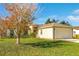 Tan house with a two-car garage and a tree in the front yard at 849 Jarnac Dr, Kissimmee, FL 34759