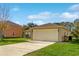 Single car garage with a beige exterior and a spacious driveway at 849 Jarnac Dr, Kissimmee, FL 34759