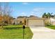 One-story house with a beige exterior and a two-car garage at 849 Jarnac Dr, Kissimmee, FL 34759