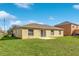 Tan house exterior with backyard at 849 Jarnac Dr, Kissimmee, FL 34759