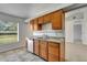 Kitchen boasts wood cabinets, granite counters, and tile floors at 849 Jarnac Dr, Kissimmee, FL 34759
