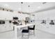 Modern white kitchen with an island and breakfast bar at 10249 Spring Lake Dr, Clermont, FL 34711